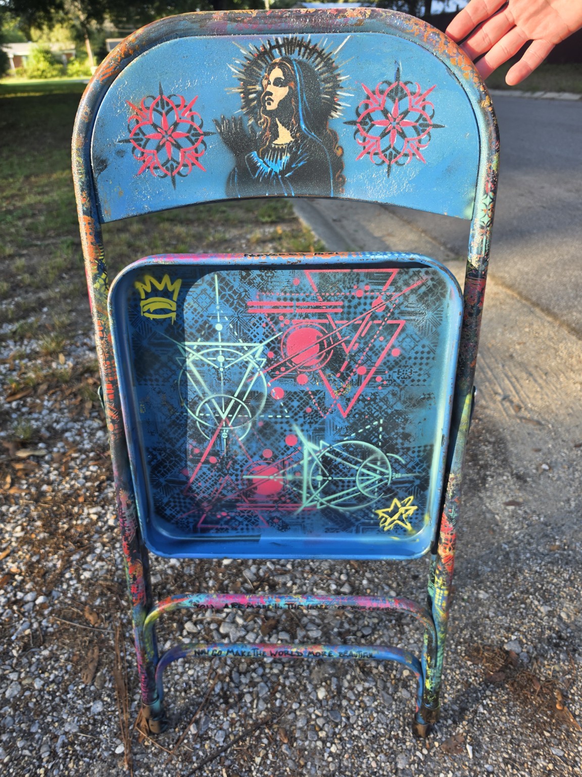 Reverse of the painted chair with a stencil portrait and geometric seat design