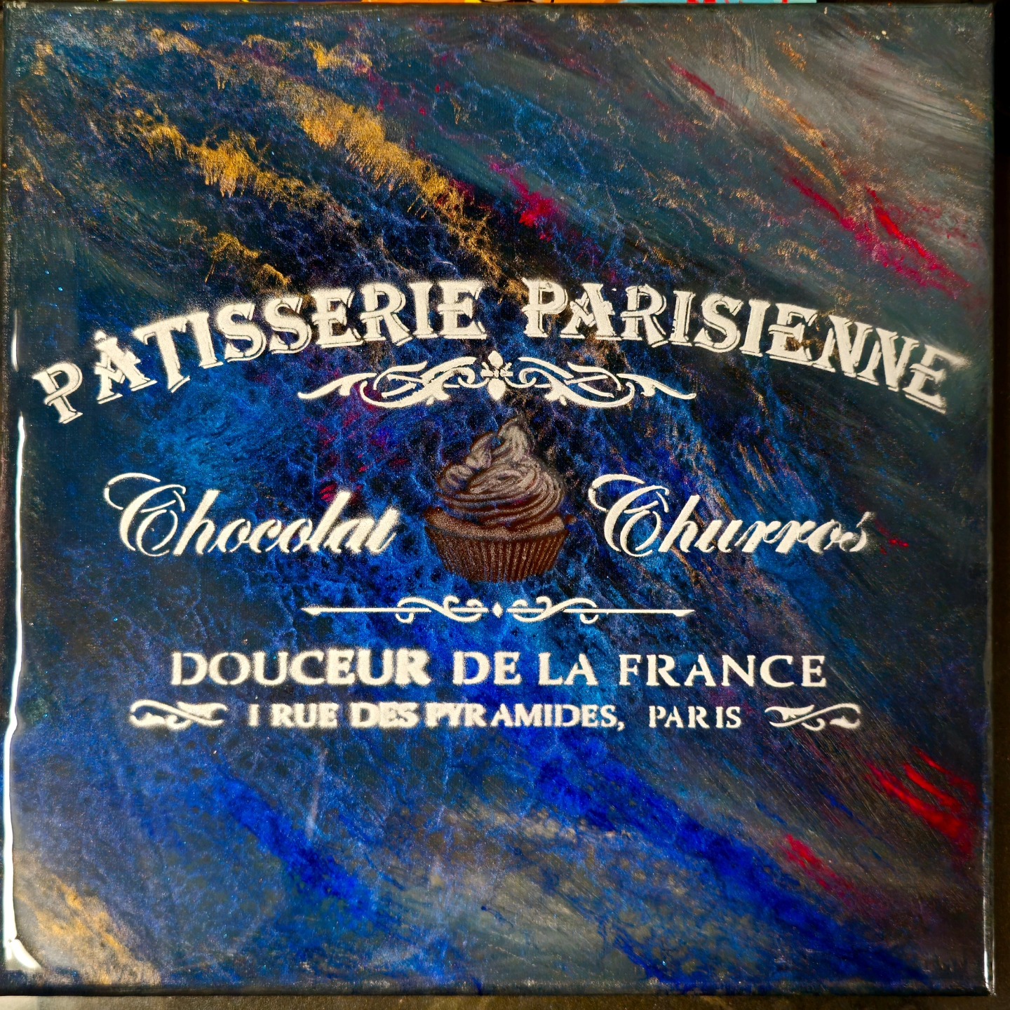 Gold Parisian patisserie stencil over blue and gold texture