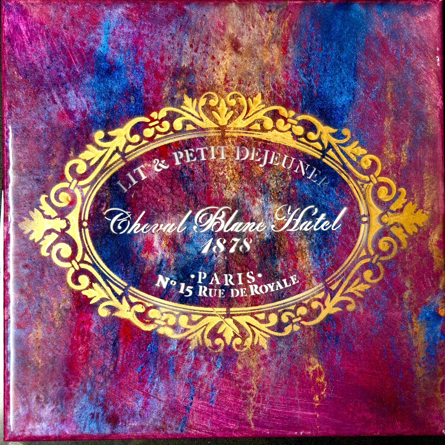 Gold ornate hotel stencil over purple and pink texture