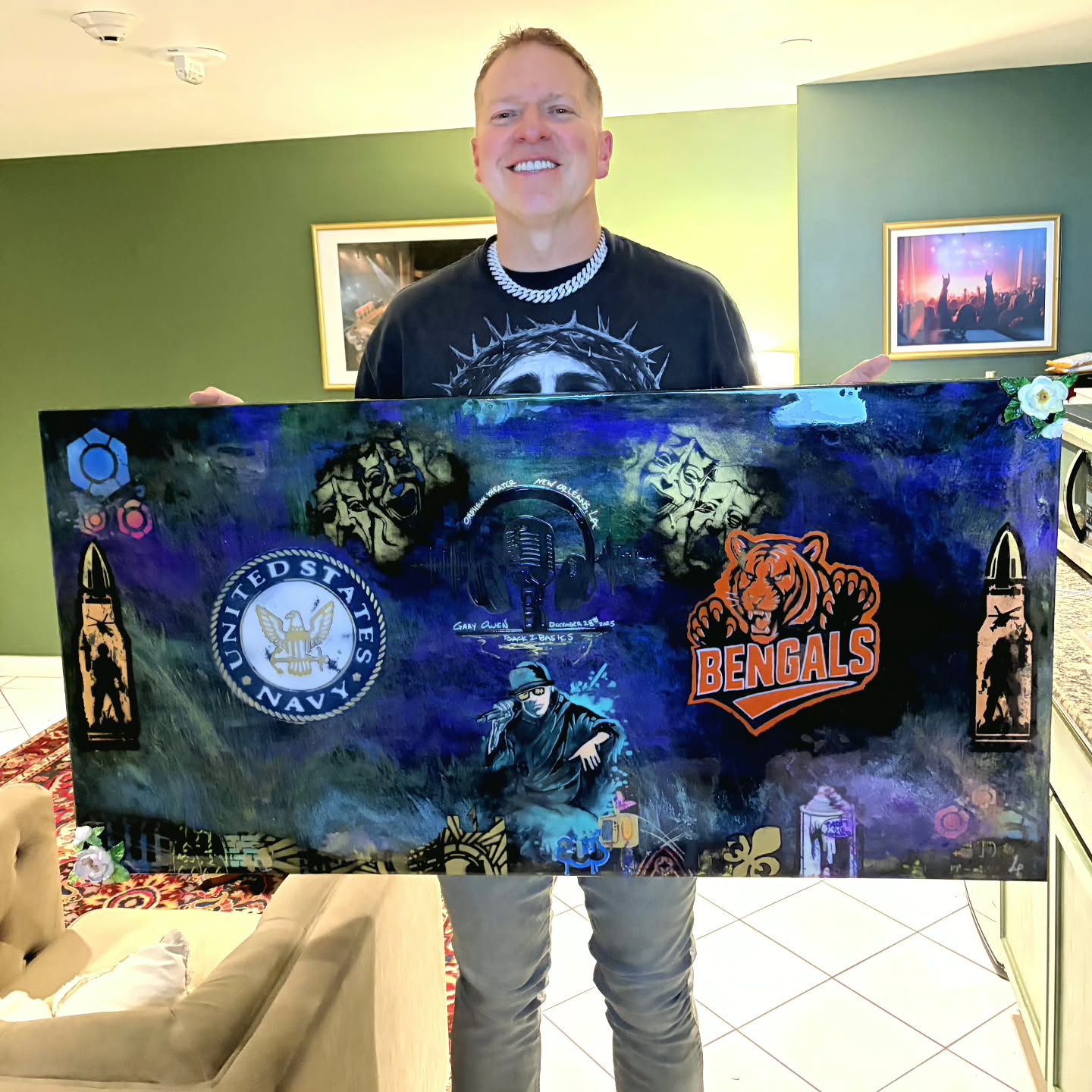 Personal tribute painting held up for a photograph