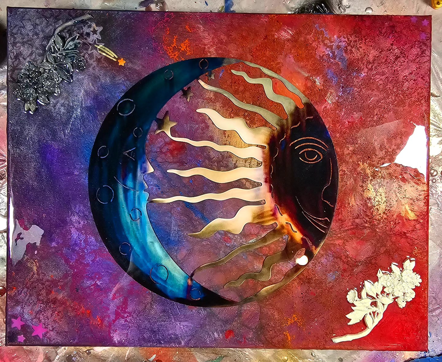Mixed media sun and moon artwork against a red and purple background